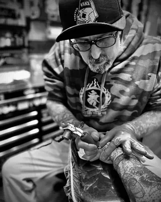 Adam Fuqua at work at Satori Tattoo