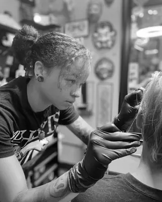 Kyra Williams at work at Satori Tattoo