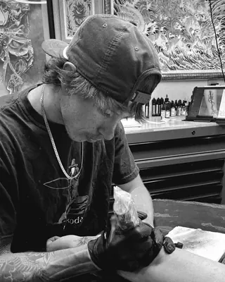 Logan Klenlen at work at Satori Tattoo