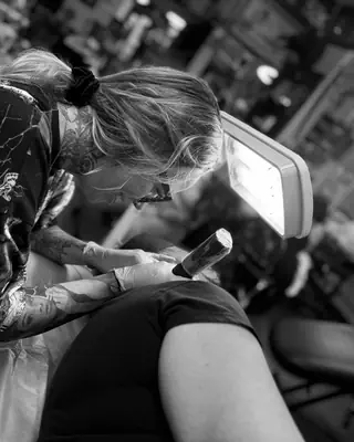Meg McLean at work at Satori Tattoo