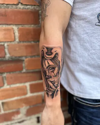 Black and grey Chicano style portrait of a woman, on a forearm