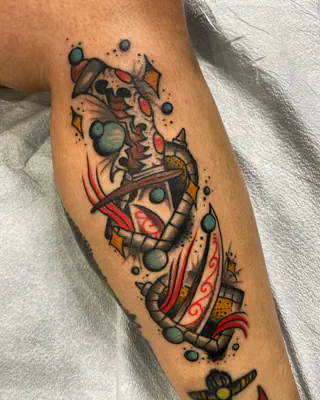 Color illustrative tattoo of a striped, winding tube with ringed planets and red and orange accents, on a calf