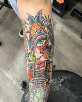 Neo traditional color portrait of a woman in an ornate headdress above a stone staircase, on a forearm