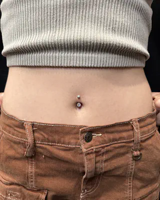 Navel piercing with a jeweled barbell