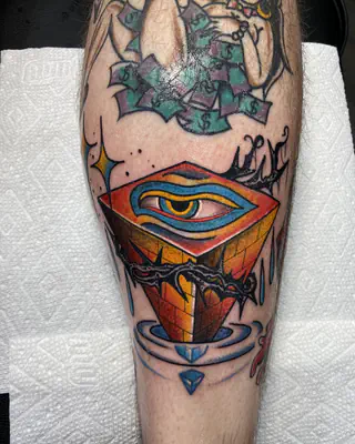 Color traditional all-seeing eye on a red pyramid wrapped in barbed wire, on a calf