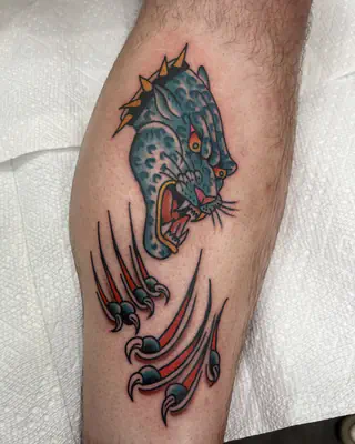 American traditional blue panther head bursting through claw marks, on a calf