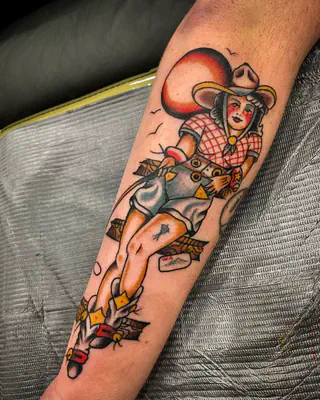 American traditional color cowgirl in a red gingham top and cowboy hat, on a forearm
