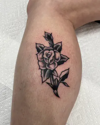 Traditional black and grey rose with leaves, on a calf