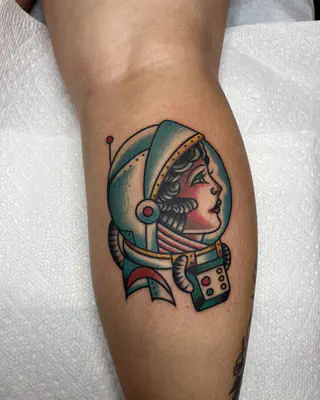 American traditional woman in a space helmet beside a pair of dice, on a calf
